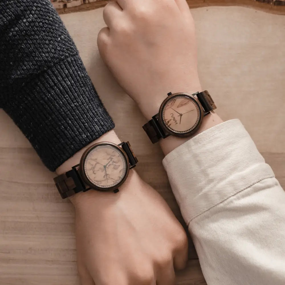Kaksi matching wooden aava 38mm watch with dark brown wooden frames and straps and light faces with subtle maps