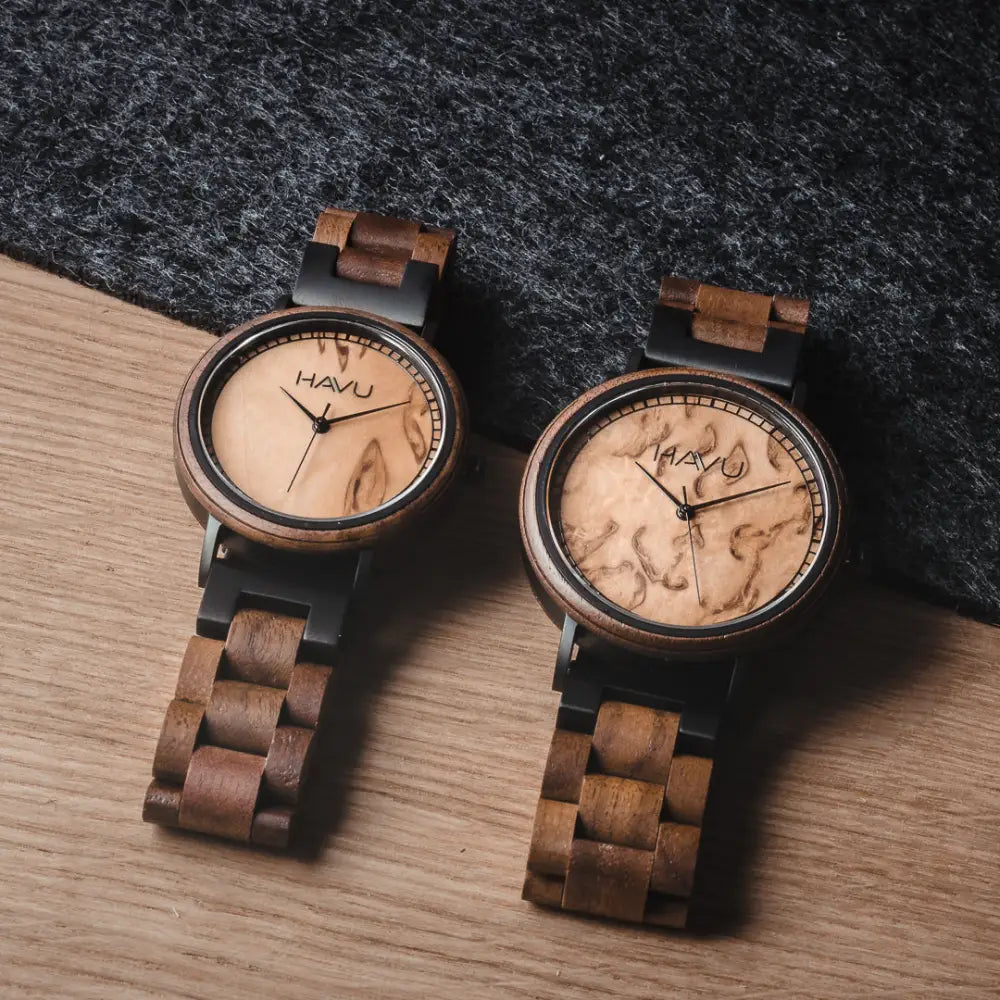 Pair of havu aava 42mm wooden watches with natural wood grain faces and dark brown woven straps