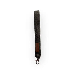 Dark gray textured fabric wristlet with brown leather tag and metal clasp avainlenkki farkku product