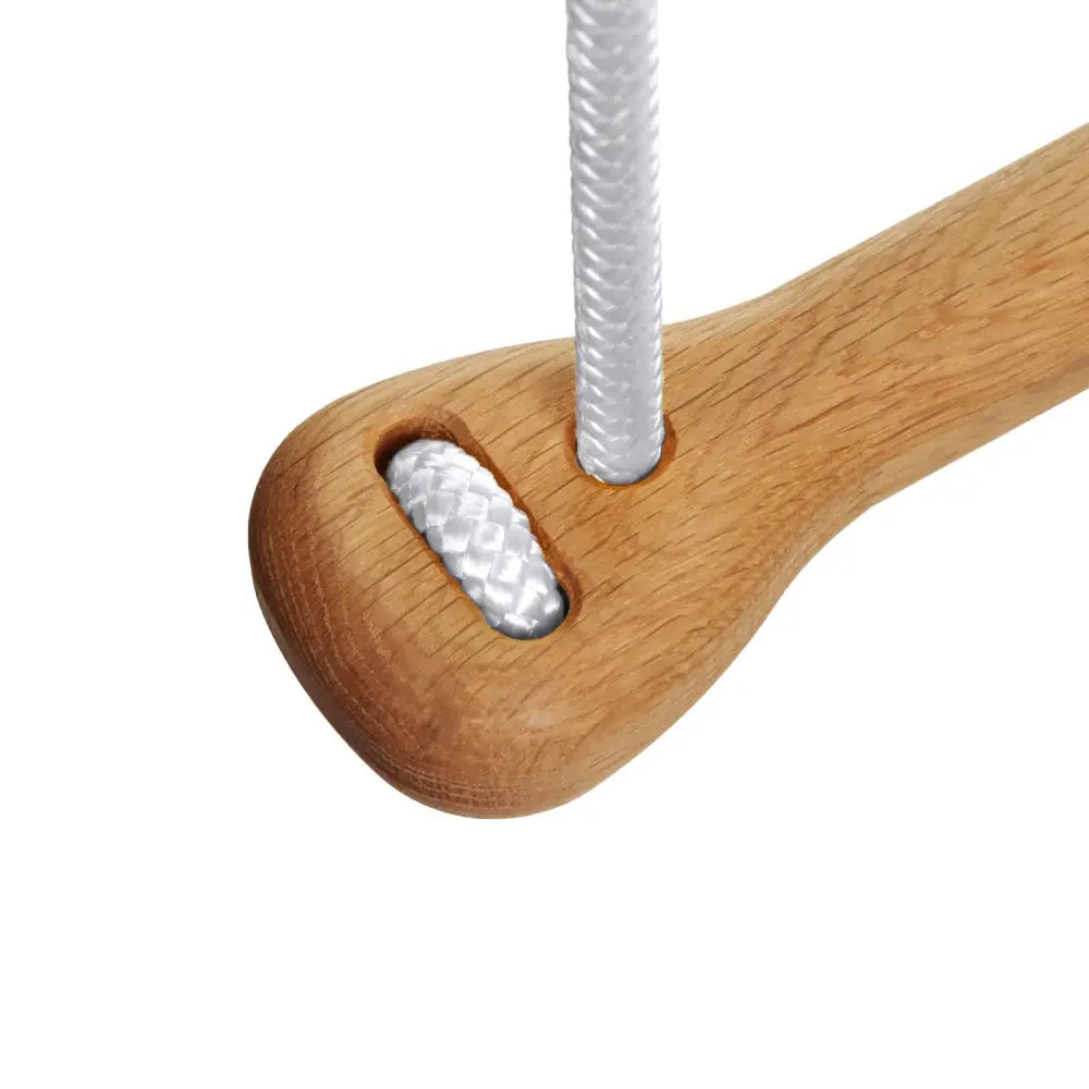 Light brown wooden climbing hold bone oak green with a white braided rope threaded through its hole