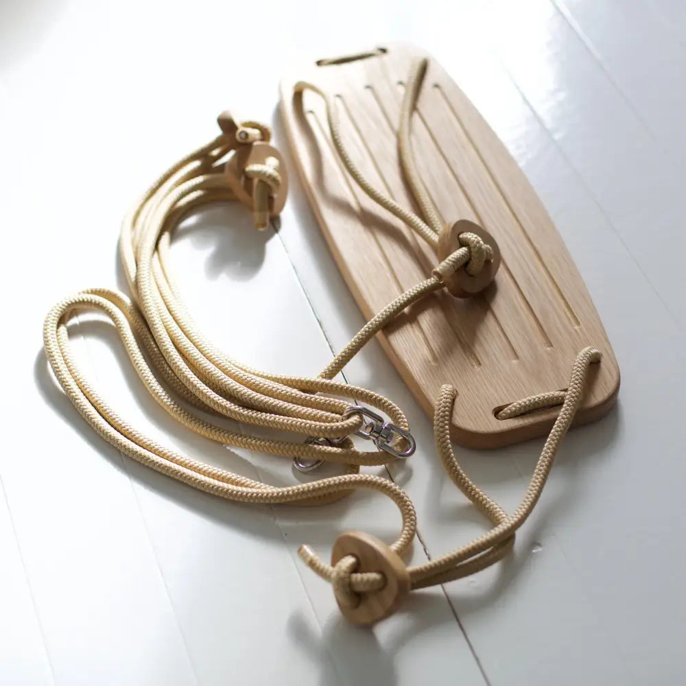 Natural wooden swing seat with beige rope straps and metal hardware classic oak beige model