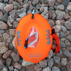 Bright orange grab bag donut buoy inflatable swim ring with blue 360swim branding and pinkish white flotation bag