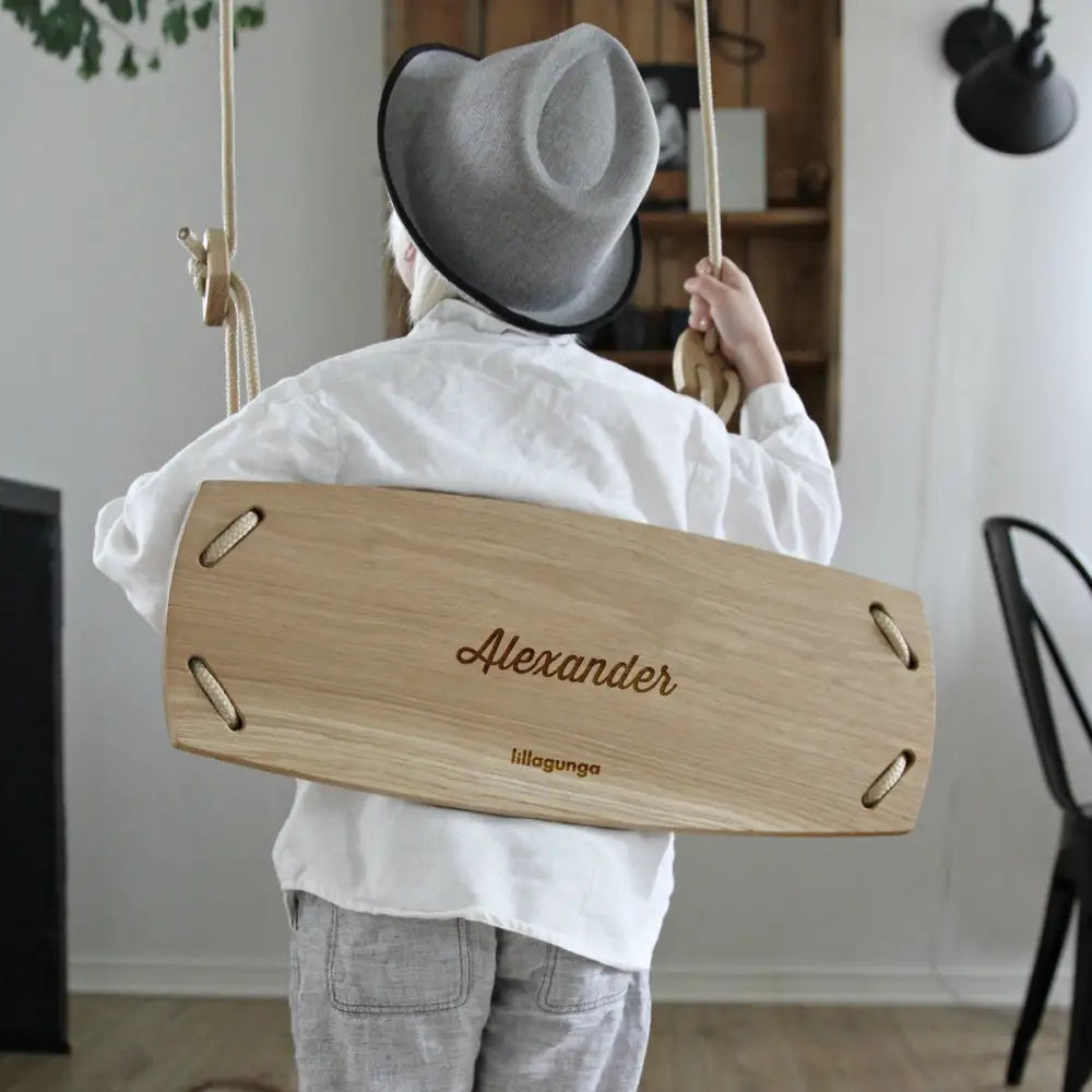 Light oak wooden swing grand personalised with engraved name Alexander and brand Lillagunga