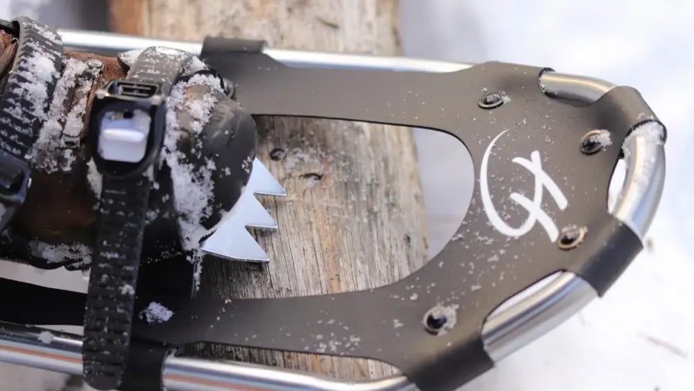 Musta ja hopea lumikenkä haghus finland 9x30 tuumaa valkoisella logolla ja metallipiikeillä pitoon