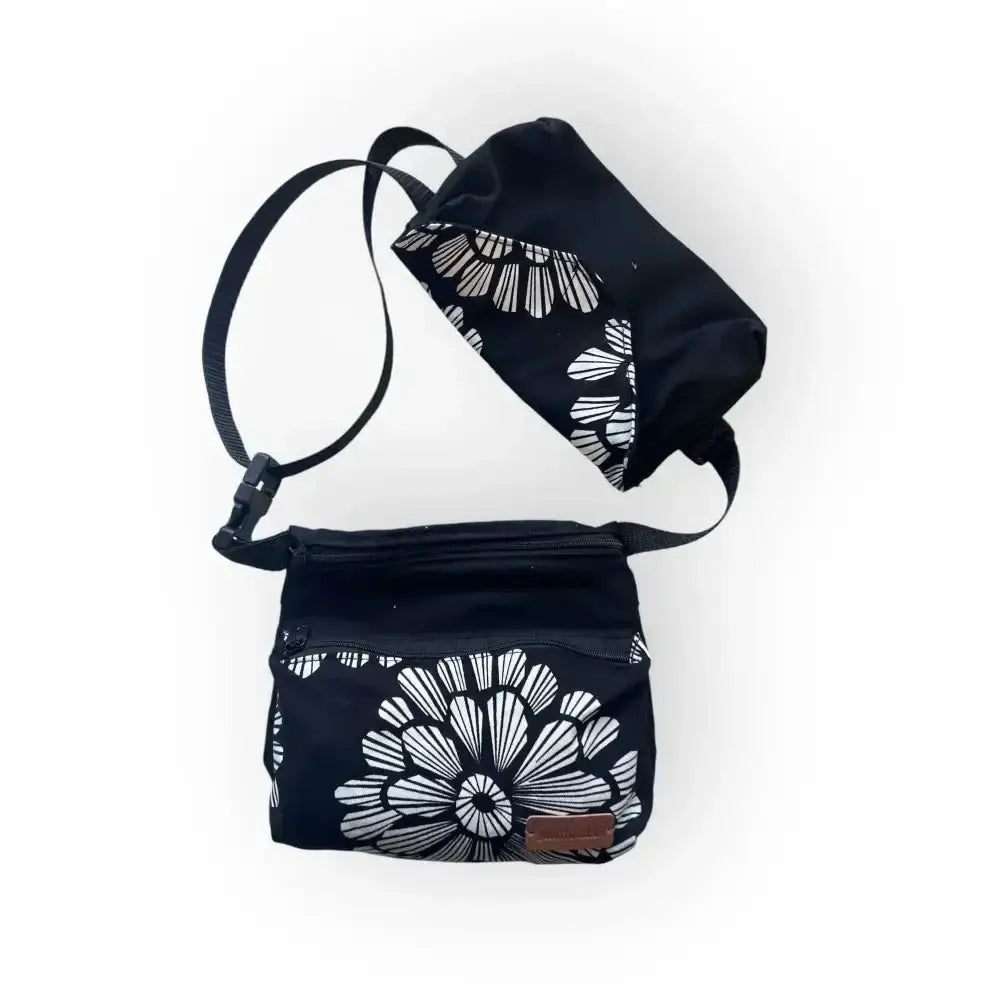 Hoitajan vyölaukku musta crossbody-laukku jossa valkoinen rohkea kukkakuosi ja säädettävä hihna