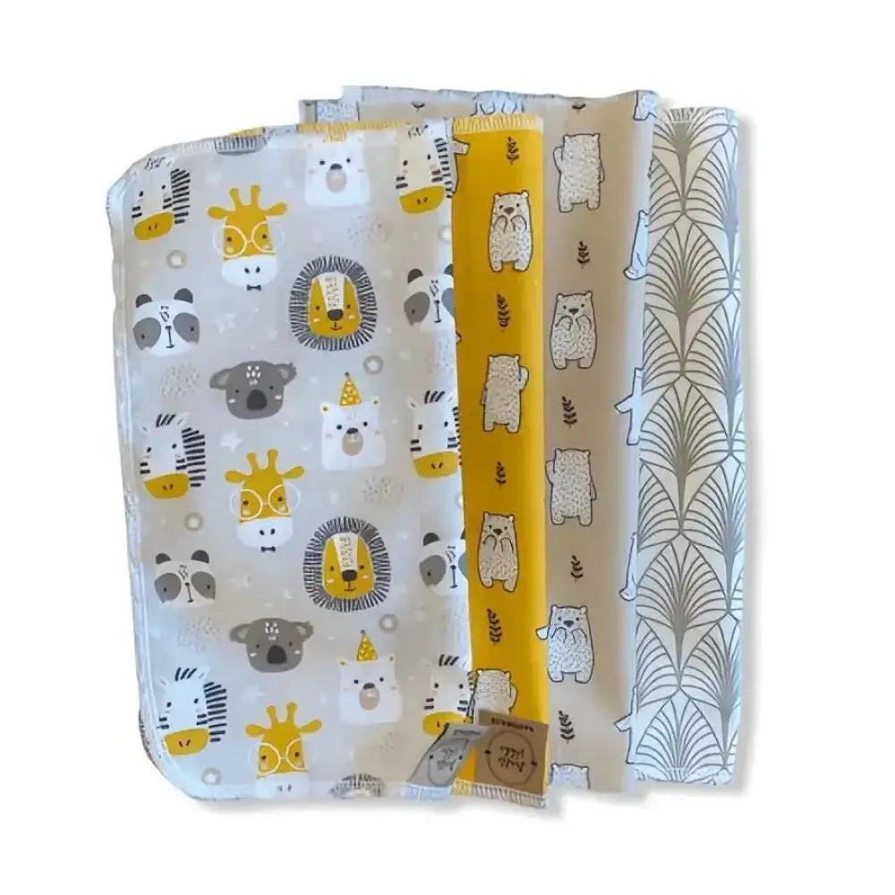 Set of four soft kestoliina baby changing pads with playful animal prints in yellow gray and white