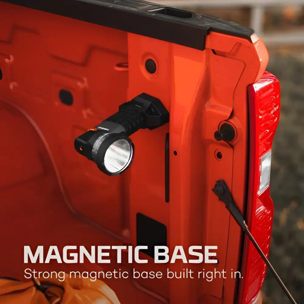 Black tactical flashlight luxtreme sl 25 r with magnetic base mounted on side of orange truck bed for outdoor use