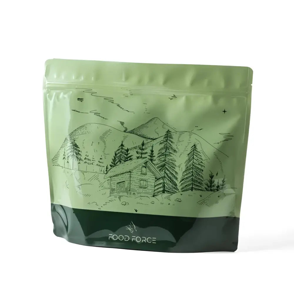 A light green resealable pouch of potato stew with beef ateria featuring a black mountain cabin drawing with pine trees