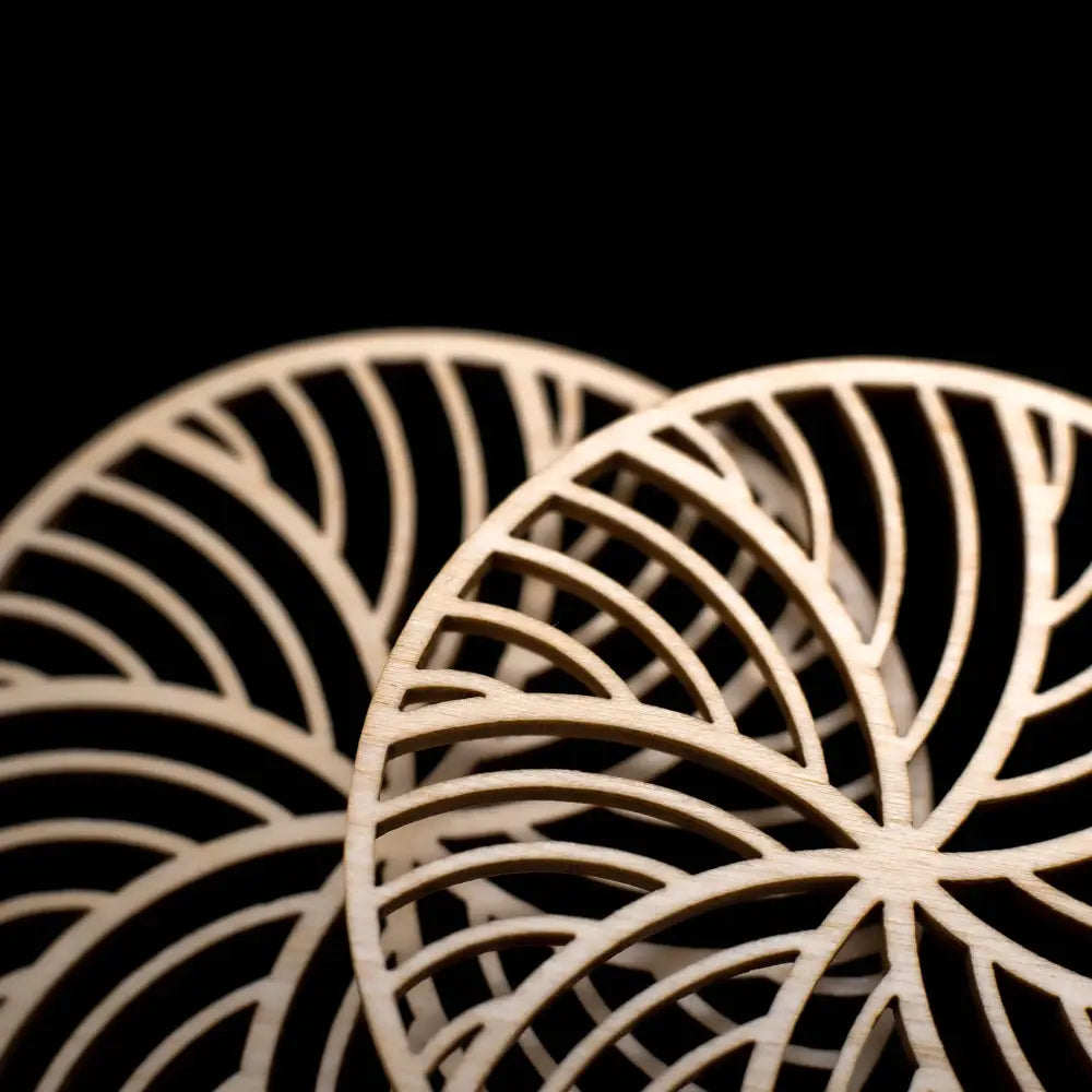 Light-colored puiset korvakorut kide with intricate radiating cut-out wooden patterns