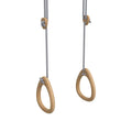 Light brown oak gymnastic rings with grey rope suspension for fitness training