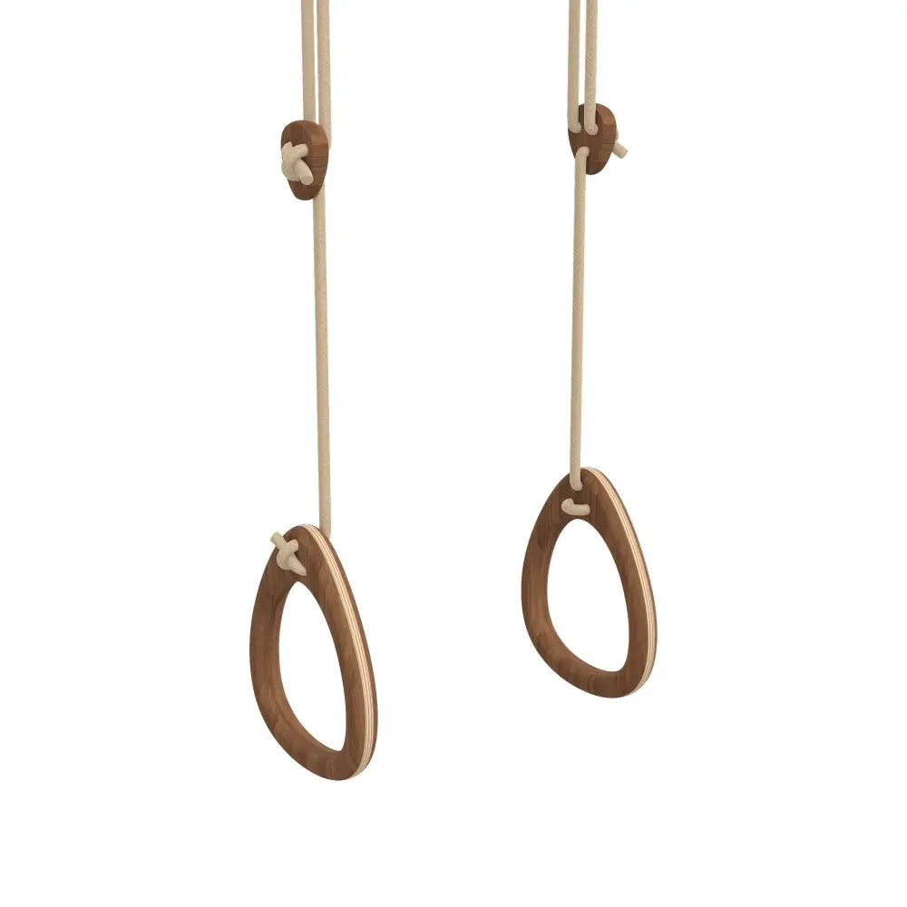 Natural wood gymnastic rings with smooth rounded design and beige light-colored rope suspension for fitness use