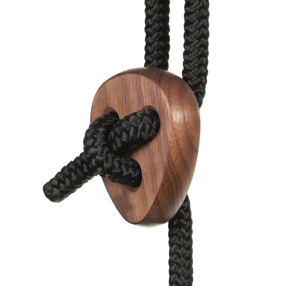 A sleek heart-shaped walnut wooden bolo tie with a rich brown finish and black braided cord