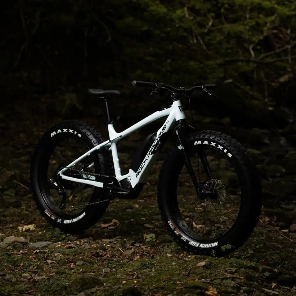 White rock machine electric mountain bike with black fat tires and sleek frame design rock machine vyöry e50r