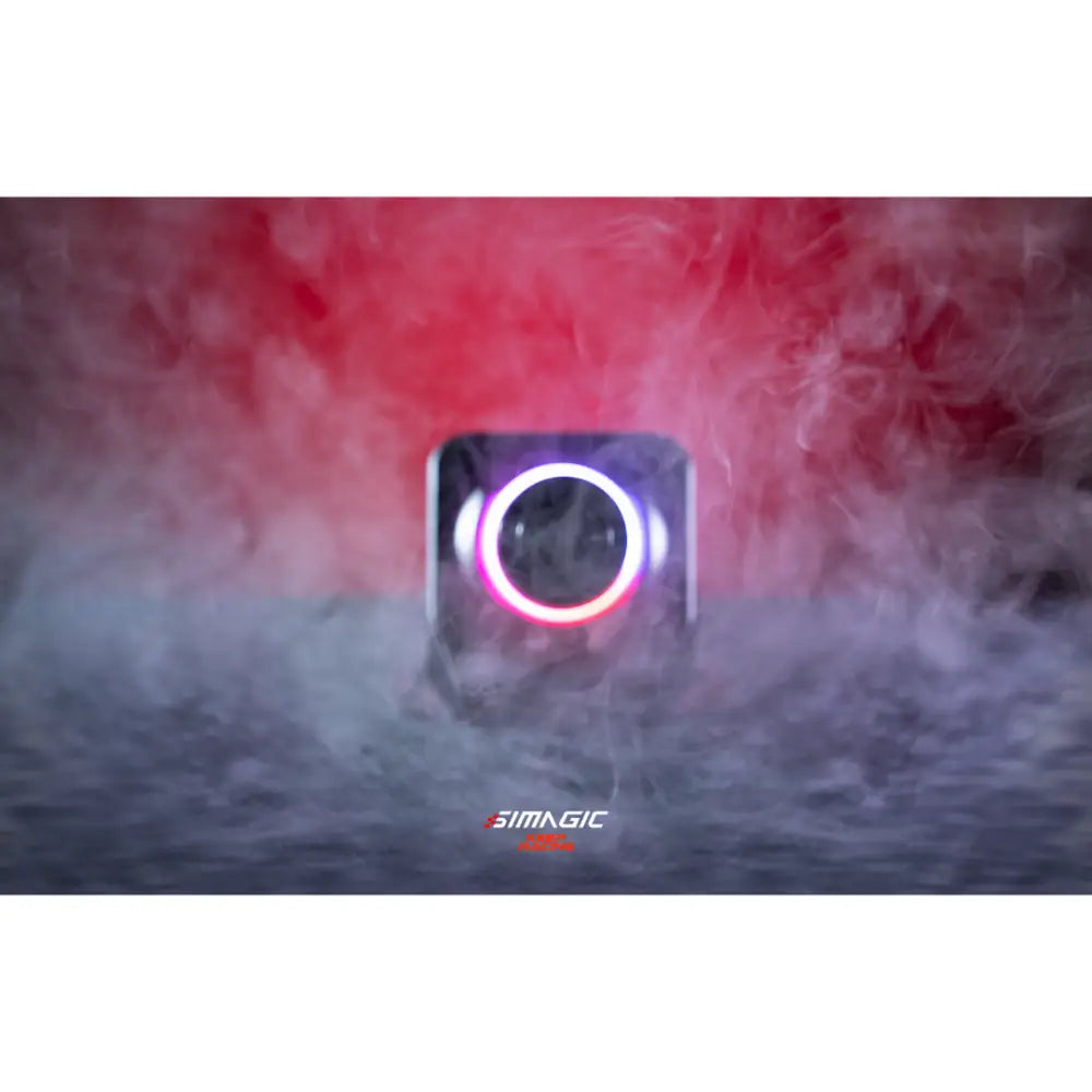 A sleek square-shaped simagic alpha evo sport wheelbase camera with glowing circular lens ring and dark metallic finish