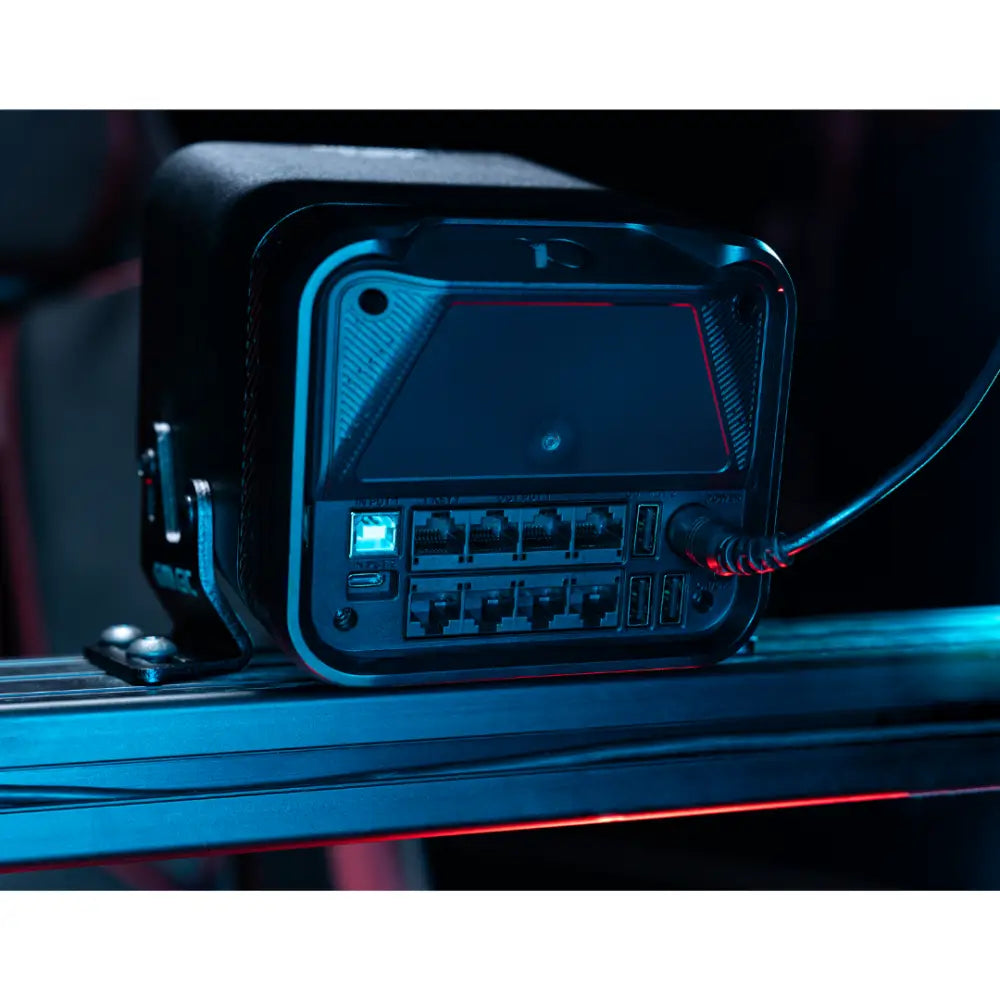 Black rugged simagic alpha evo sport wheelbase 9nm with illuminated blue led ports and red accent lighting visible from back