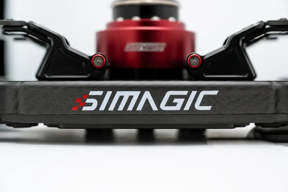 Black carbon fiber simagic fx pro formula steering wheel base with white logo red checkered flag and red cylindrical component