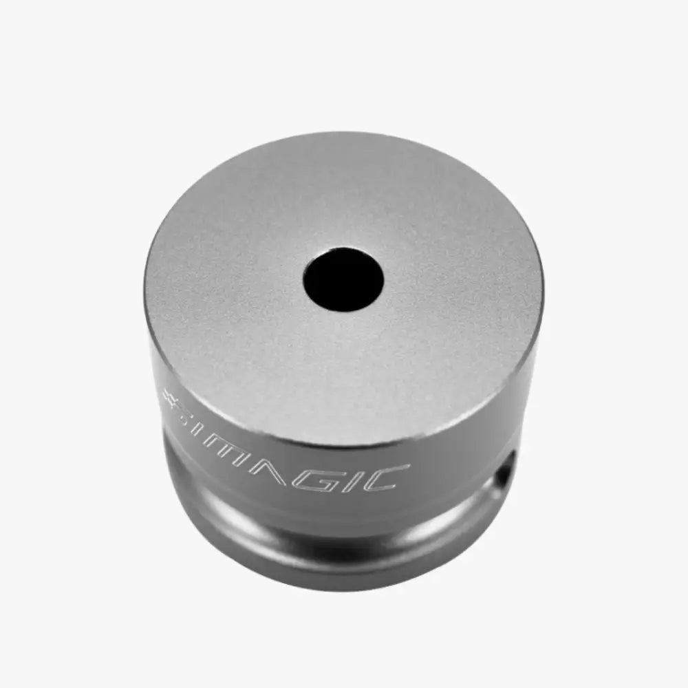 Silver metallic cylindrical simagic steering wheel mount adapter with central hole and engraved simagic branding