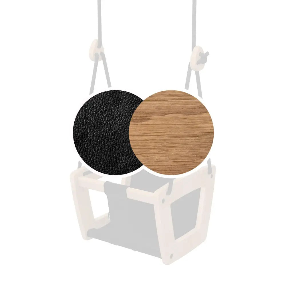 Valkoinen muovinen vauvan keinu, jossa musta ja puuviilupäällinen istuin, nimeltään toddler oak black leather