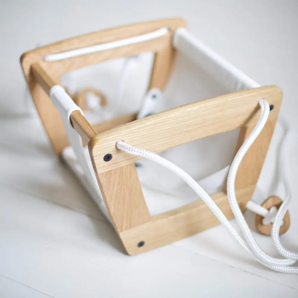 Light wood-framed toddler play cube oak with white leather soft interior and white rope handles