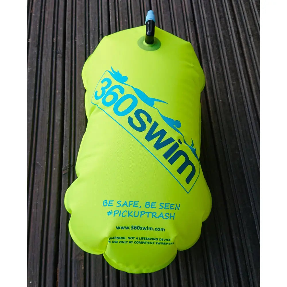 Bright neon green inflatable tow float with blue logo text and black valve on top for swimming safety