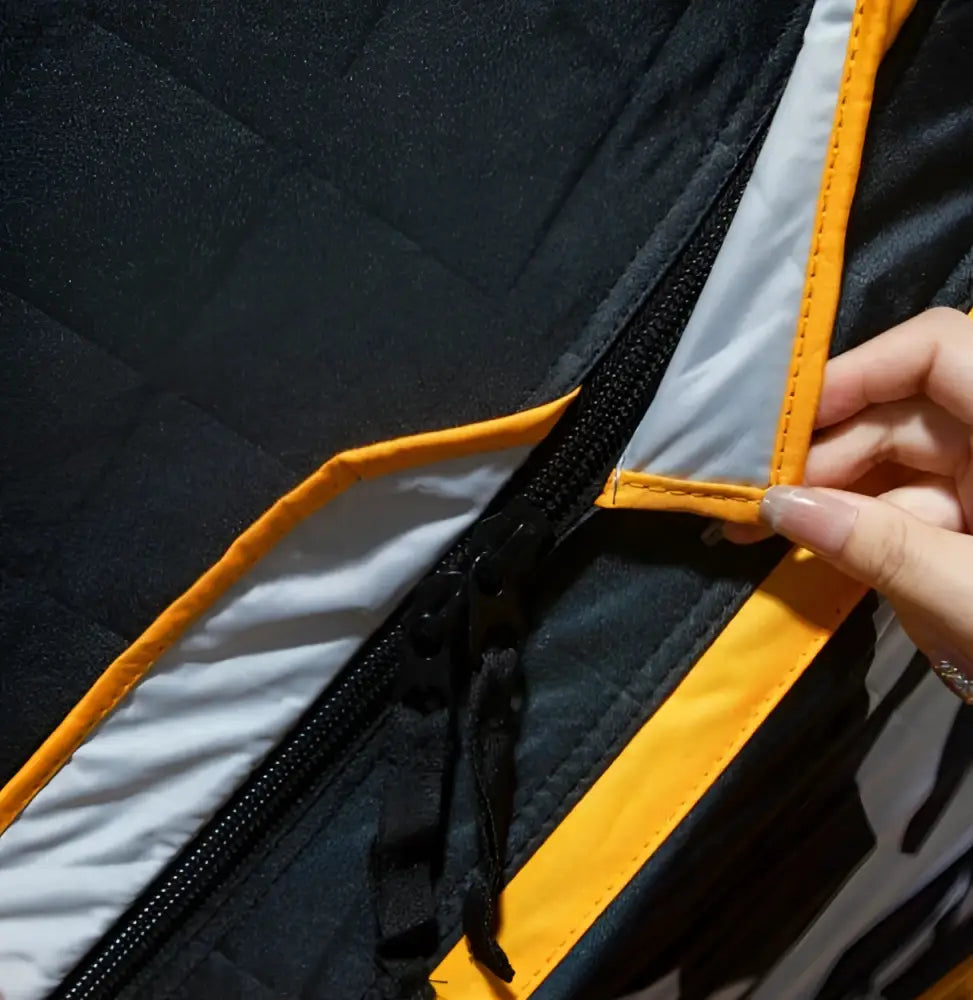 Black quilted väinö bunker thermal extreme xxl pilkkiteltta with bright orange and reflective silver zipper trim