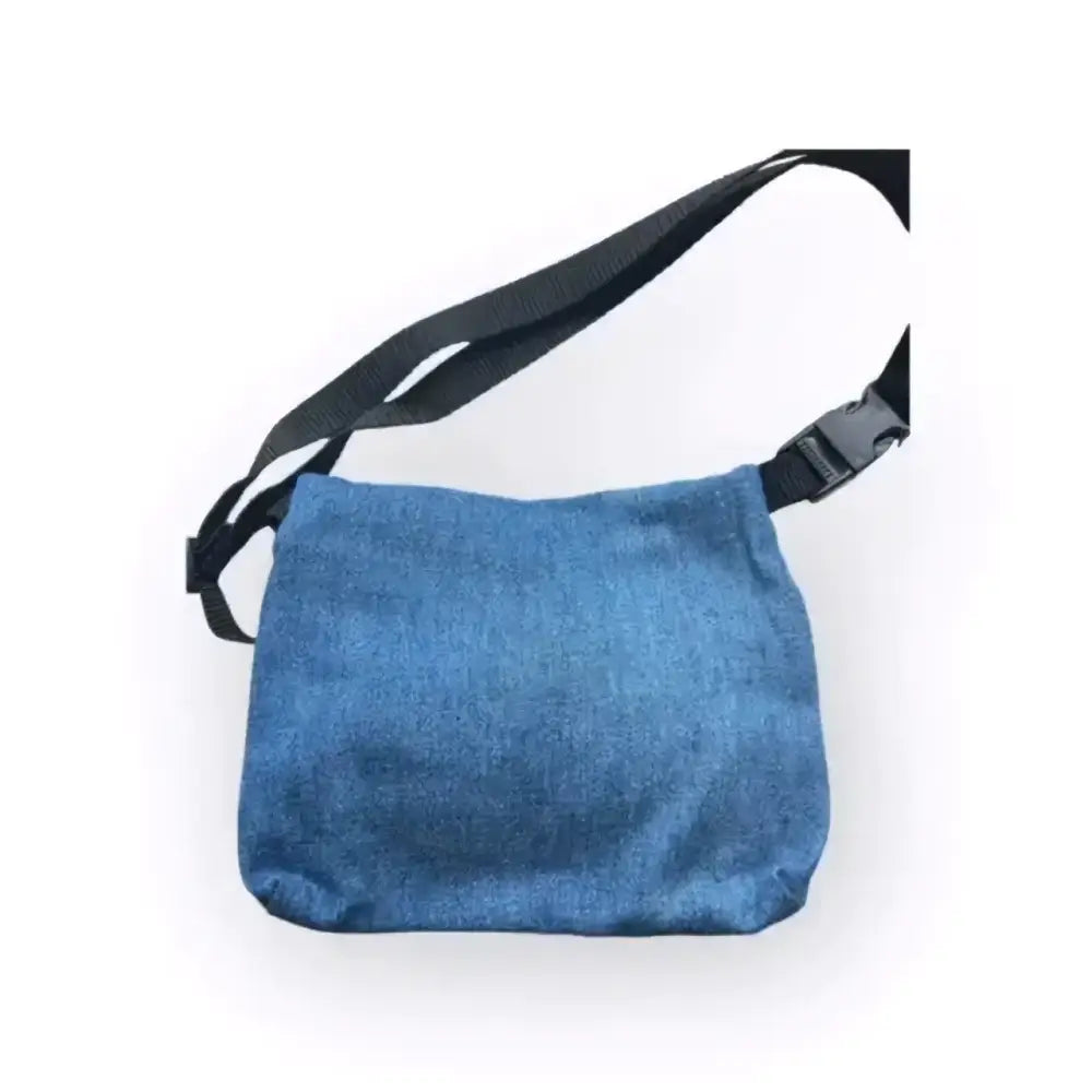 Sininen farkkukangasta valmistettu vyölaukku mustalla säädettävällä olkahihnalla crossbody-käyttöön